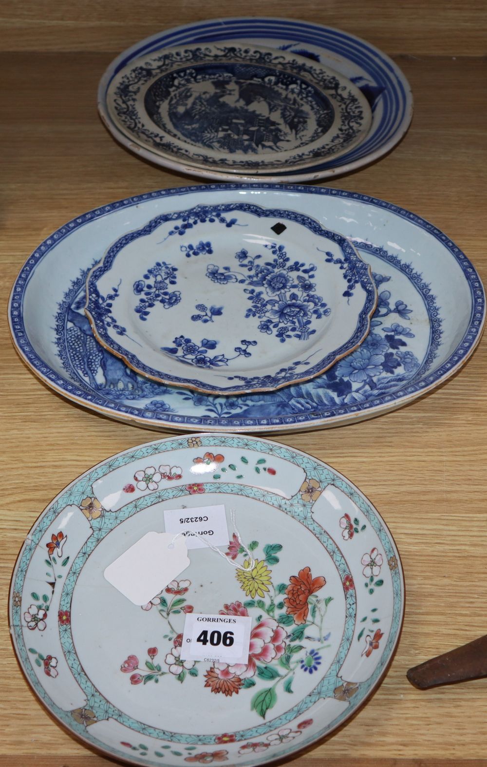 An early 19th century Chinese floral plate, a Chinese blue and white plate and meat platter, together with two other dishes